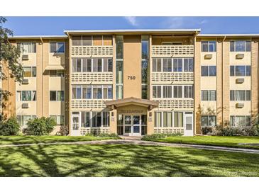 Apartment building exterior featuring well-maintained landscaping and architectural details at 750 S Clinton St # 2C, Denver, CO 80247