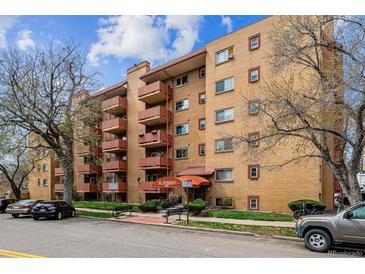 Brick apartment building with balconies, mature trees, and easy street parking at 625 N Pennsylvania St # 208, Denver, CO 80203