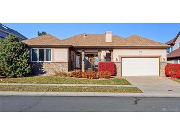 Ranch style home with attached two-car garage and manicured lawn at 486 S Youngfield Cir, Lakewood, CO 80228