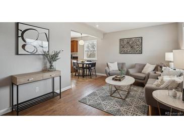 Bright living room featuring modern decor, stylish furniture, and hardwood floors at 1760 S Yuma St, Denver, CO 80223