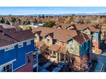A picturesque aerial view of townhomes showcasing a charming neighborhood with mountain views in the background at 7352 E 7Th Ave # 7, Denver, CO 80230