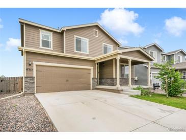 Charming two-story home with a spacious two-car garage and welcoming front porch at 47312 Lilac Ave, Bennett, CO 80102