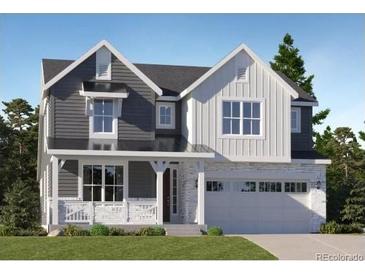 New construction home showcasing a two-story design with a welcoming front porch and an attached two-car garage at 747 Raindance St, Erie, CO 80516