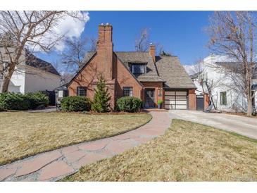 Charming brick two-story home featuring a stone walkway and attached two car garage at 629 Bellaire St, Denver, CO 80220