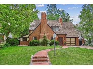 Charming brick home featuring a beautiful lawn, mature trees, and welcoming red brick pathway to the front door at 629 Bellaire St, Denver, CO 80220