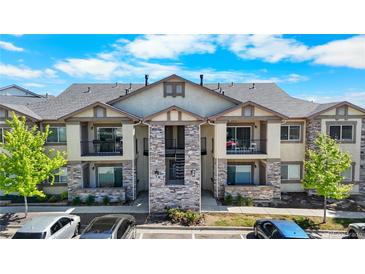 Inviting two-story condo building with stone accents, private balconies, and well-maintained landscaping at 875 E 78Th Ave # 21, Denver, CO 80229