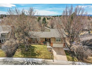 Charming ranch home with mature trees, a well-manicured lawn, and a two-car garage, blending curb appeal with comfort at 3014 E Fremont Dr, Centennial, CO 80122