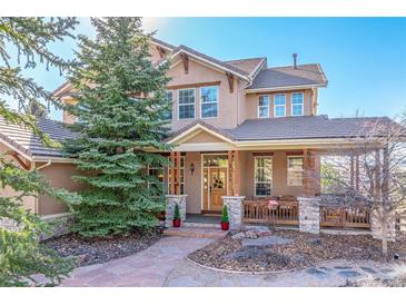 Charming two-story home features a stone-accented facade and a welcoming covered porch at 3125 Starling Ct, Castle Rock, CO 80109