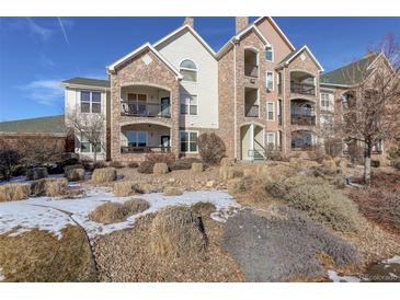 Attractive 2-story condo building with stone accents and balconies at 19049 E Warren Dr # 105, Aurora, CO 80013