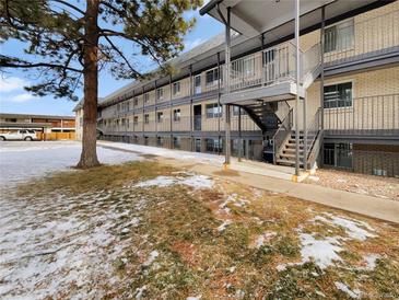 Apartment building exterior with landscaping and parking at 1723 Robb St # 31, Lakewood, CO 80215