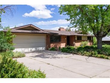 Charming brick home with a two-car garage, mature trees, and a spacious driveway at 962 S Beech St, Lakewood, CO 80228