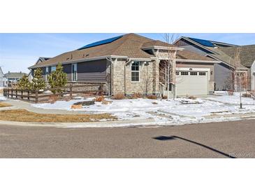 Nice two-story house with stone and siding accents, a two-car garage, and a landscaped yard at 8885 S Tibet Ct, Aurora, CO 80016