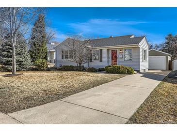 Charming home featuring a well-maintained front yard with mature trees and a quaint detached garage at 2370 S Ogden St, Denver, CO 80210