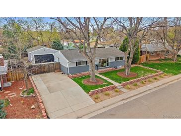 Charming single-story home with a well-maintained front yard and detached garage at 6482 S Cedar St, Littleton, CO 80120