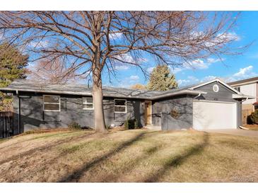 Charming single-story home featuring a well-maintained front yard and attached garage at 4751 S Xenia St, Denver, CO 80237