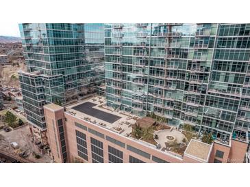 Stunning aerial view of modern high-rise buildings with reflective glass and rooftop lounge at 1700 Bassett St # 820, Denver, CO 80202