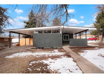 Modern home featuring a stylish gray brick facade and covered parking area at 6087 S Elizabeth Way, Centennial, CO 80121