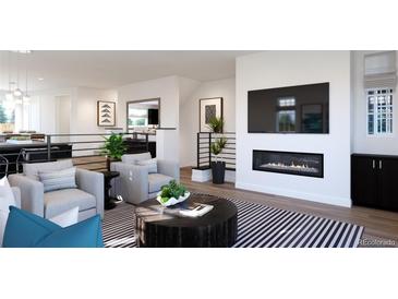 Bright living room featuring a modern fireplace, TV, neutral furniture, and contemporary decor at 3877 Bahn Ct, Evergreen, CO 80439