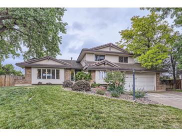 Charming home featuring a well-manicured lawn and a two-car garage with beautiful landscaping at 10397 Yates Ct, Westminster, CO 80031