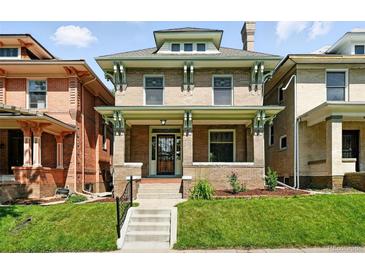 Charming brick two-story home with a manicured front lawn and inviting front porch at 1582 Steele St, Denver, CO 80206