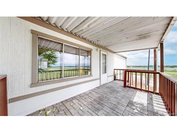 Charming covered front porch with brick pavers and lovely views of the neighboring community at 8509 Colorado Ct, Denver, CO 80229