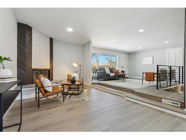 Bright living room features a modern fireplace and stylish seating at 4140 S Inca St, Englewood, CO 80110