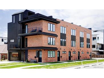 Modern brick building with multiple units and private balconies at 3408 W 17Th Ave, Denver, CO 80204