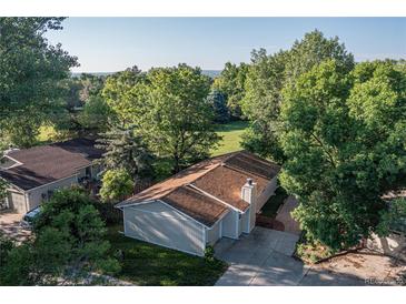 Charming single-story home featuring a well-maintained lawn, mature trees, and a spacious driveway at 6396 Twin Lakes Rd, Boulder, CO 80301