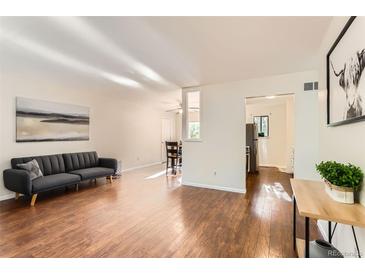 Bright living room featuring hardwood floors, modern furnishings, and great natural light at 6396 Twin Lakes Rd, Boulder, CO 80301