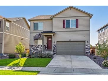 Two-story house with a two-car garage and landscaped lawn at 803 William Way, Brighton, CO 80603