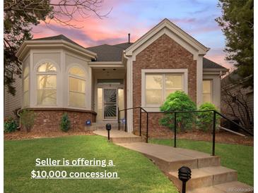 Charming single-story home featuring a brick facade, manicured lawn, and inviting walkway at 1011 S Valentia St # 3, Denver, CO 80247
