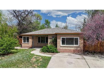 Charming brick home with a well-manicured lawn and inviting walkway, perfect for suburban living at 3031 W 20Th Ave, Denver, CO 80211