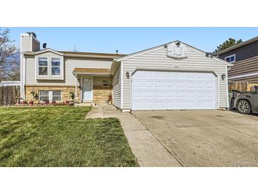 Charming two-story home featuring a two-car garage, landscaped front yard, and inviting entrance at 12425 Bellaire Dr, Thornton, CO 80241