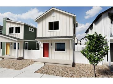 Charming two-story home featuring white siding, a red front door, and modern design elements at 13111 E 103Rd Pl, Commerce City, CO 80022