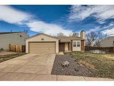 Charming one-story home featuring a brick chimney and attached two-car garage at 2735 S Uravan St, Aurora, CO 80013