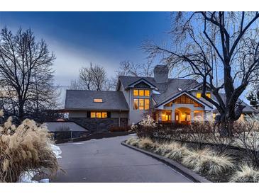 Elegant home with a sprawling driveway and mature landscaping, offering a private and serene setting at 6483 S Prince St, Littleton, CO 80120