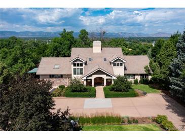 Stunning home with lush landscaping, a neutral palette and mountain views from the front lawn at 6483 S Prince St, Littleton, CO 80120
