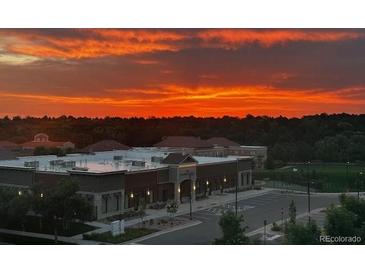 Commercial building showing the parking lot at sunrise, with red and orange clouds at 5677 S Park Pl # 311A, Greenwood Village, CO 80111