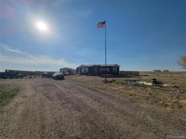 Ranch style home with detached garage and large yard at 6255 Wolf Creek Rd, Strasburg, CO 80136