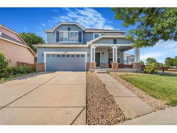 Charming two-story home with a covered front porch, large driveway and beautiful landscaping at 10301 E 112Th Way, Commerce City, CO 80640