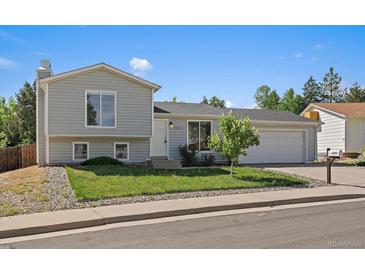 Charming two-story home with a well-manicured lawn, inviting curb appeal and a two car garage at 1043 Lilac Ct, Broomfield, CO 80020