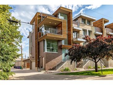 Modern townhome showcasing wood and brick accents, balconies, and professional landscaping at 2758 W 22Nd Ave, Denver, CO 80211