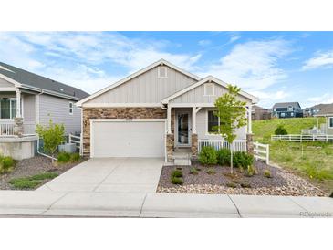 Charming single-Gathering home with stone accents, well-maintained landscaping, and an attached two-car garage at 2060 Peralta Loop, Castle Rock, CO 80104