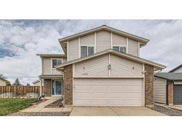 Charming two-story home features a two-car garage, brick accents, and neutral siding at 18843 E Colorado Dr, Aurora, CO 80017