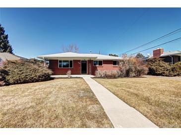 Charming single-story brick home featuring a well-maintained lawn and inviting walkway at 2921 E Colorado Ave, Denver, CO 80210