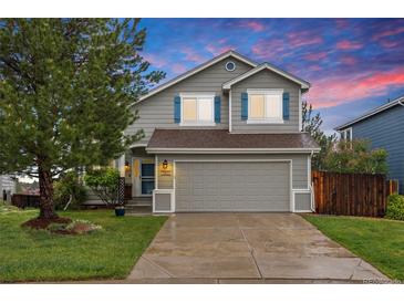 Charming two-story home with a well-manicured lawn, gray siding, and a two-car garage at 7888 Canvasback Cir, Littleton, CO 80125