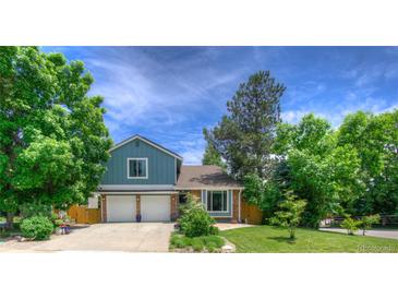 Charming two-story home with a well-manicured lawn and a two-car garage at 8140 S Storm King Peak, Littleton, CO 80127