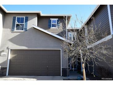 Charming home exterior with a two-car garage and decorative blue shutters at 11883 E Fair Ave, Greenwood Village, CO 80111