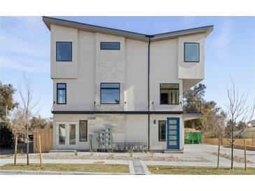Contemporary home featuring a modern design, large windows, and a blue accent door at 1678 Tabor St, Lakewood, CO 80215
