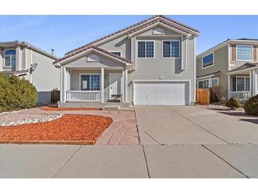 Charming two-story home featuring a covered front porch and a two-car garage in a desirable neighborhood at 20781 E 48Th Pl, Denver, CO 80249